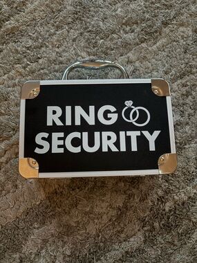 Ring security case for ring bearer with Bold White Text on Black.